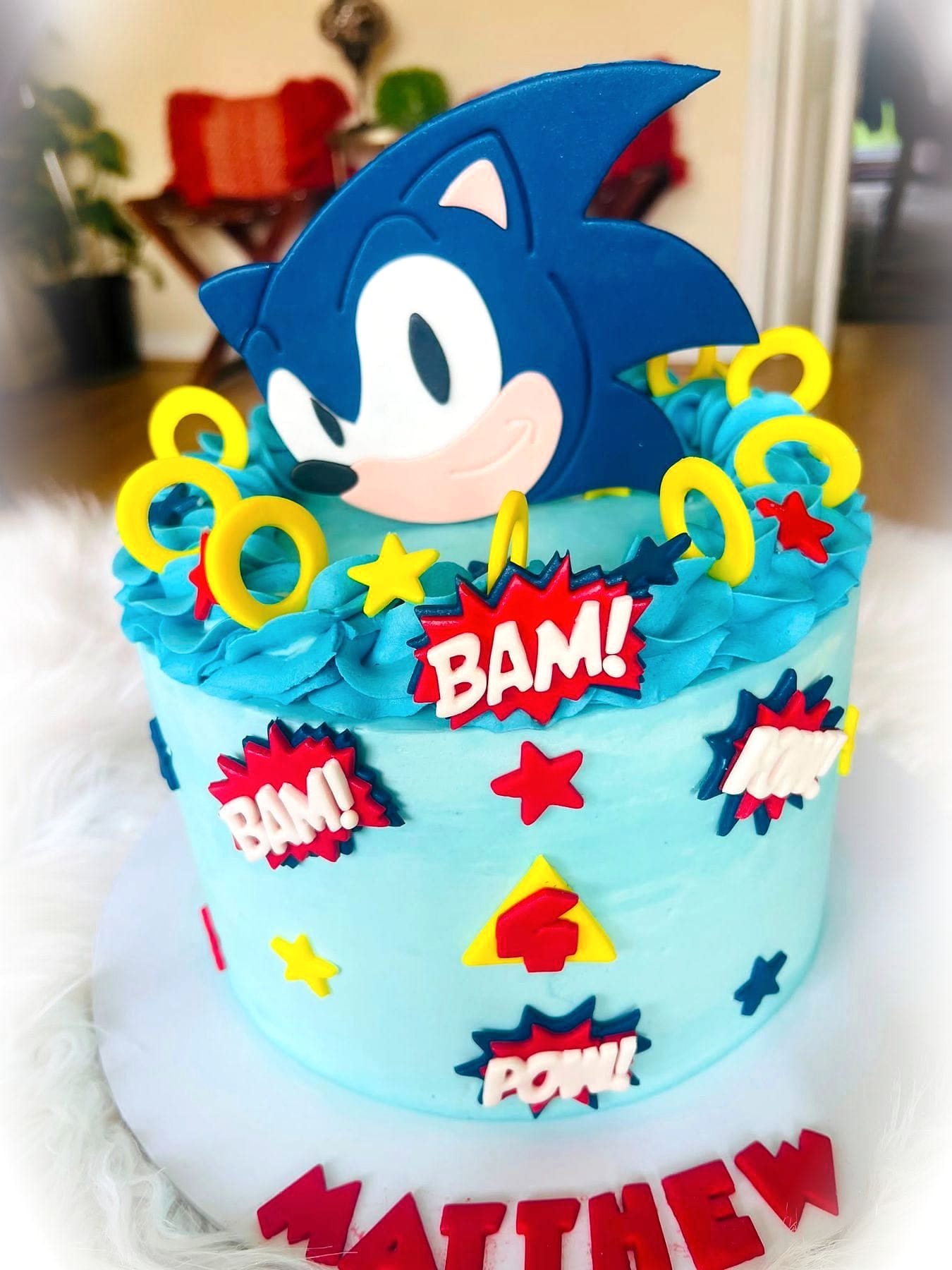 Comic Pop Birthday Cake by SpongyBakes — A bright blue buttercream cake with comic-book stars, speech bursts and a character topper.