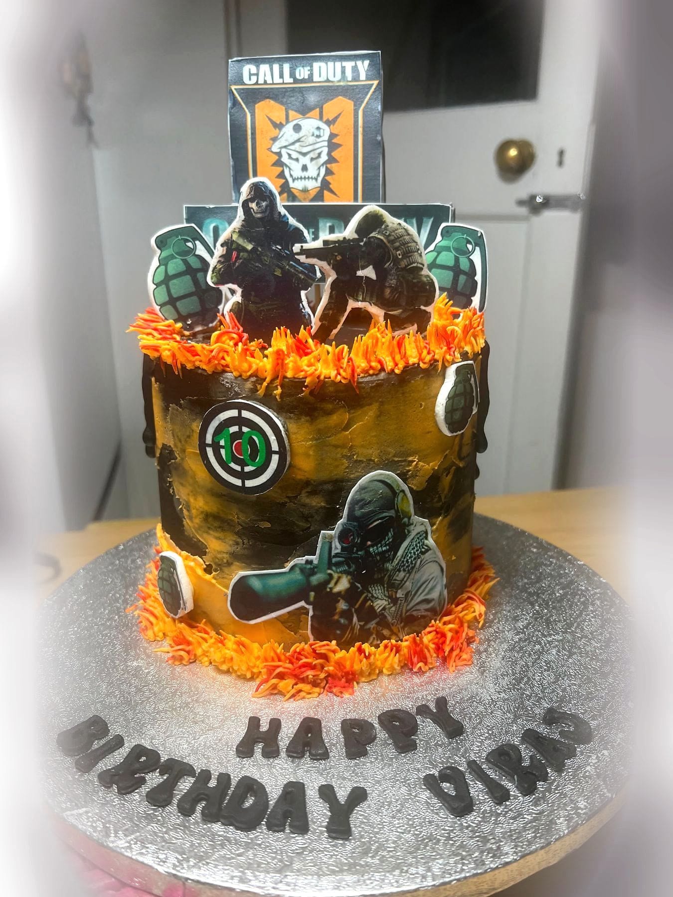 Combat Mission Birthday Cake by SpongyBakes — A military-themed cake with a printed panel, flame detailing and piped board lettering.