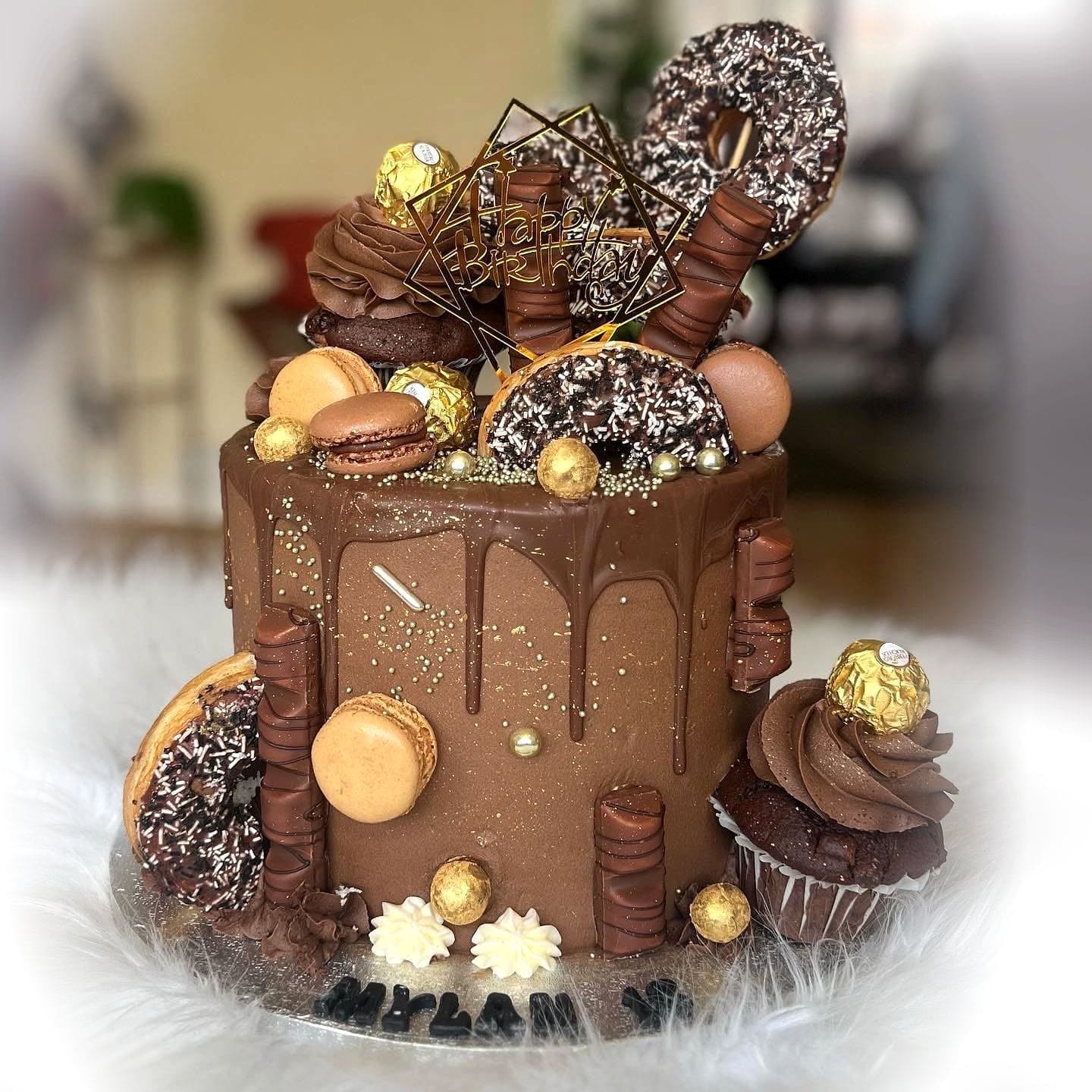 Chocolate Overload Drip Cake by SpongyBakes — A chocolate drip cake loaded with truffles, macarons, cupcakes and chocolate shards.