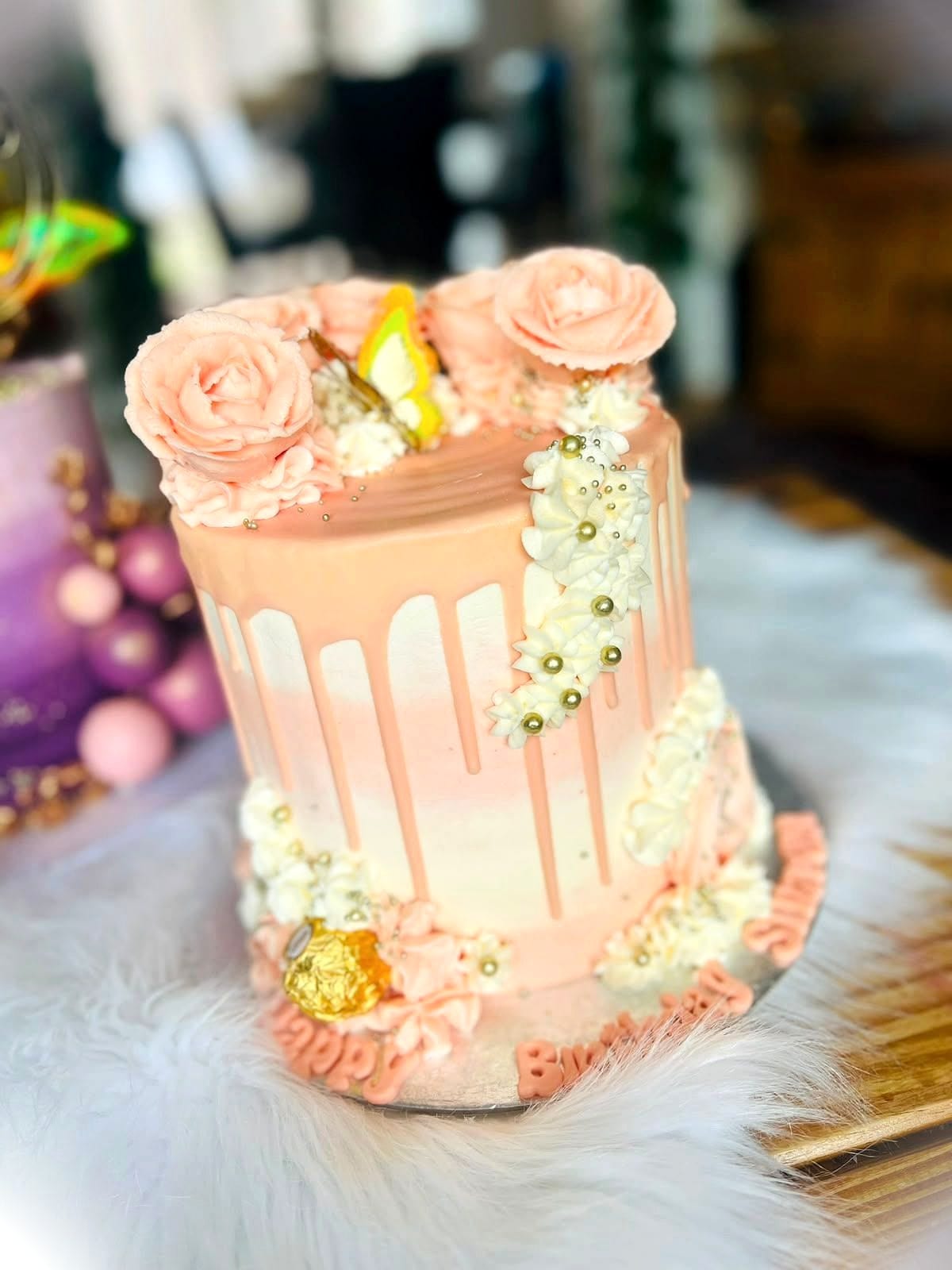 Peach Rose Drip Cake by SpongyBakes — A peach cake with a white drip, piped roses and gold sprinkle detailing.