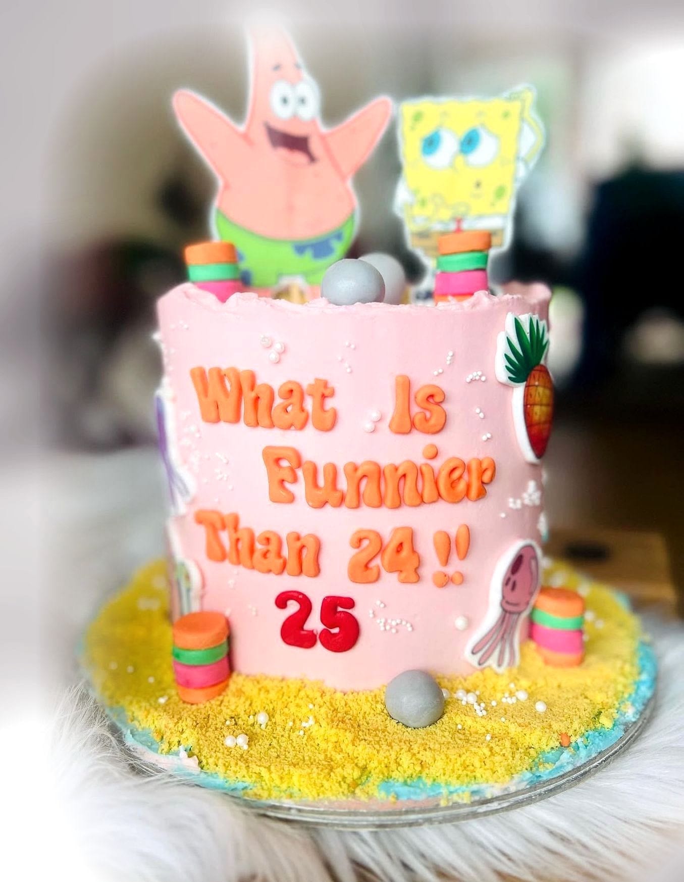 Seaside Cartoon Birthday Cake by SpongyBakes — A pink beach cake with a sand base, fondant lettering and cartoon character toppers.