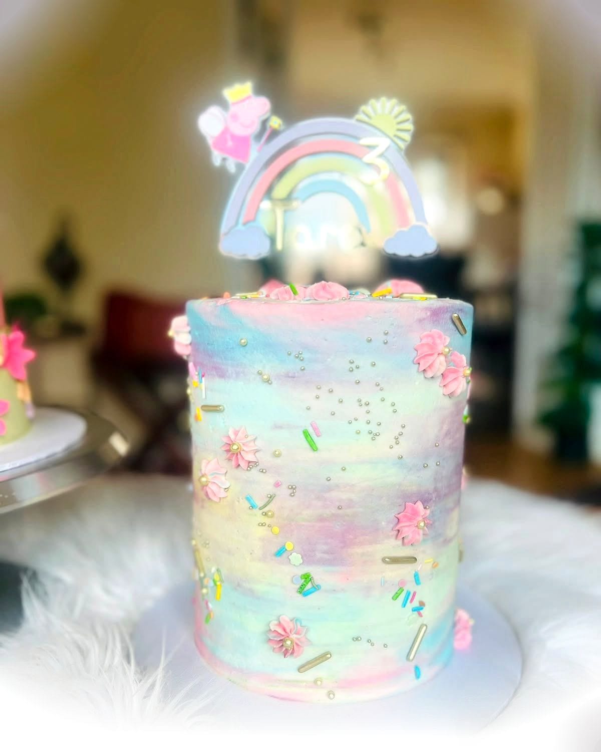 Pastel Rainbow Birthday Cake by SpongyBakes — A watercolour pastel cake with piped blossom and a fondant rainbow topper.