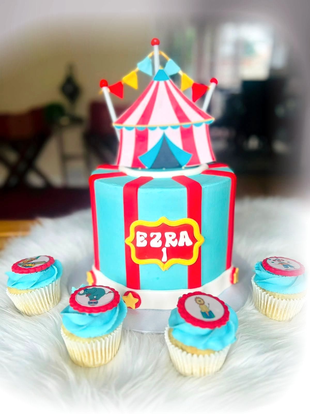 Circus Birthday Cake by SpongyBakes — A striped circus cake with a fondant big-top roof, bunting and matching cupcakes.
